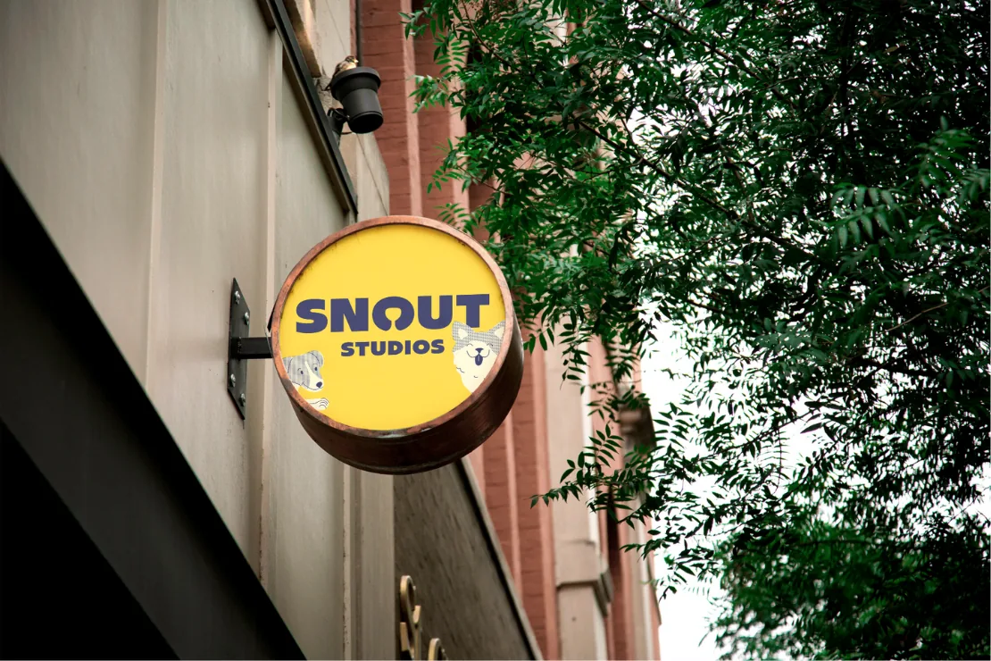 The yellow Snout Studios blade sign mounted outside the studio